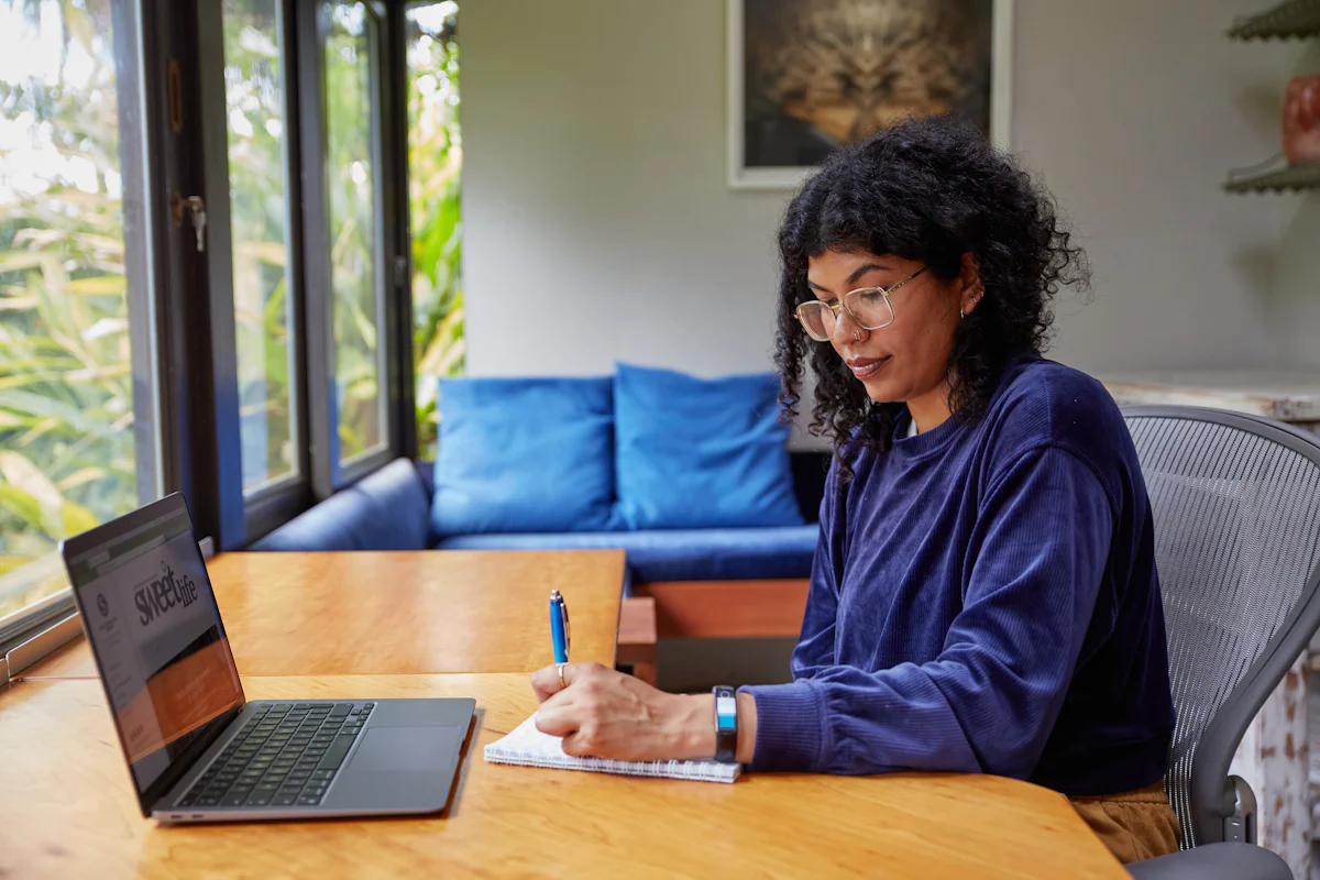 A woman working through business data on her laptop