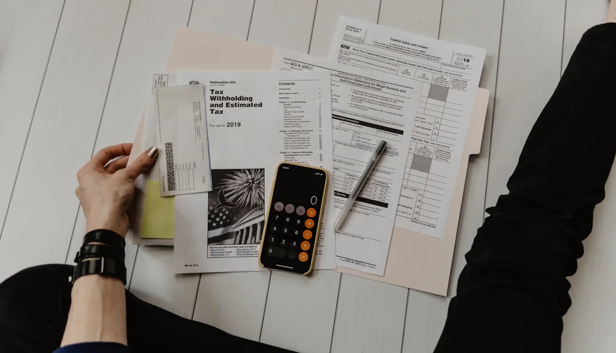 Financial statements on a desk with a pen and calculator
