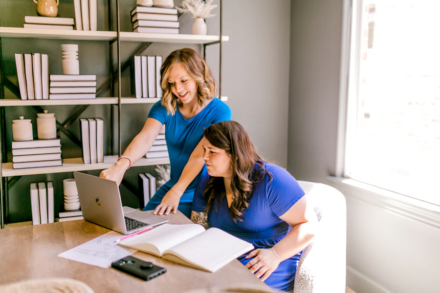 Two colleagues working together on a laptop